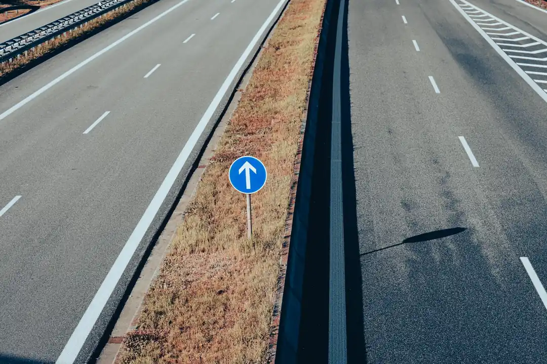 高速道路の上空から撮影された、矢印が描かれた道路標識