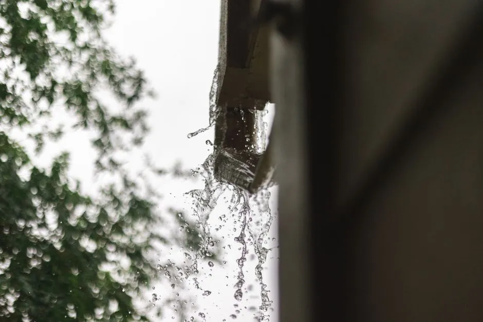 Close-up of rainwater pouring from a gutter