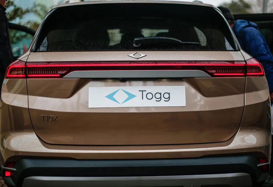 Rear view of a brown TOGG T10X electric SUV.