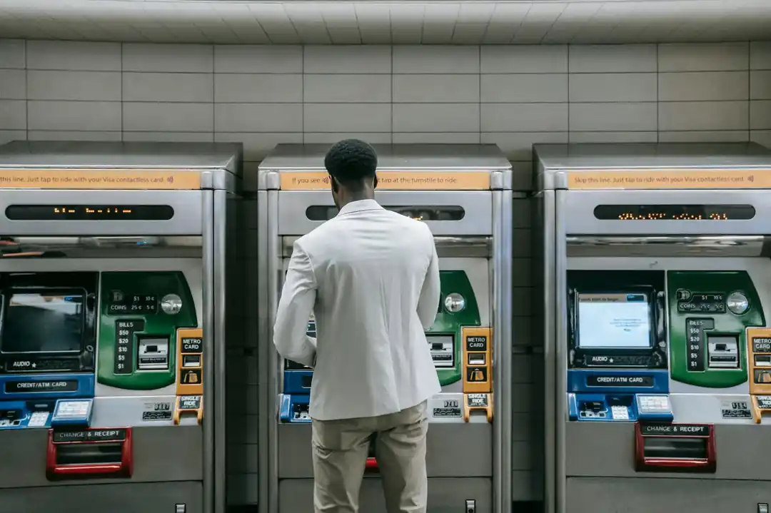 トランジットステーションのメトロ券売機を利用するビジネスプロフェッショナル。